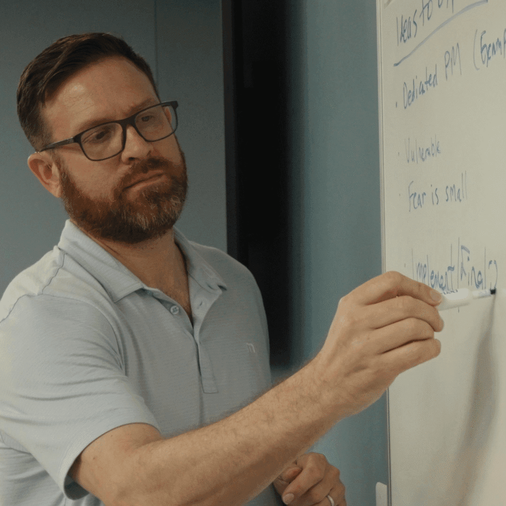 Josh Tarbutton working a problem at the whiteboard